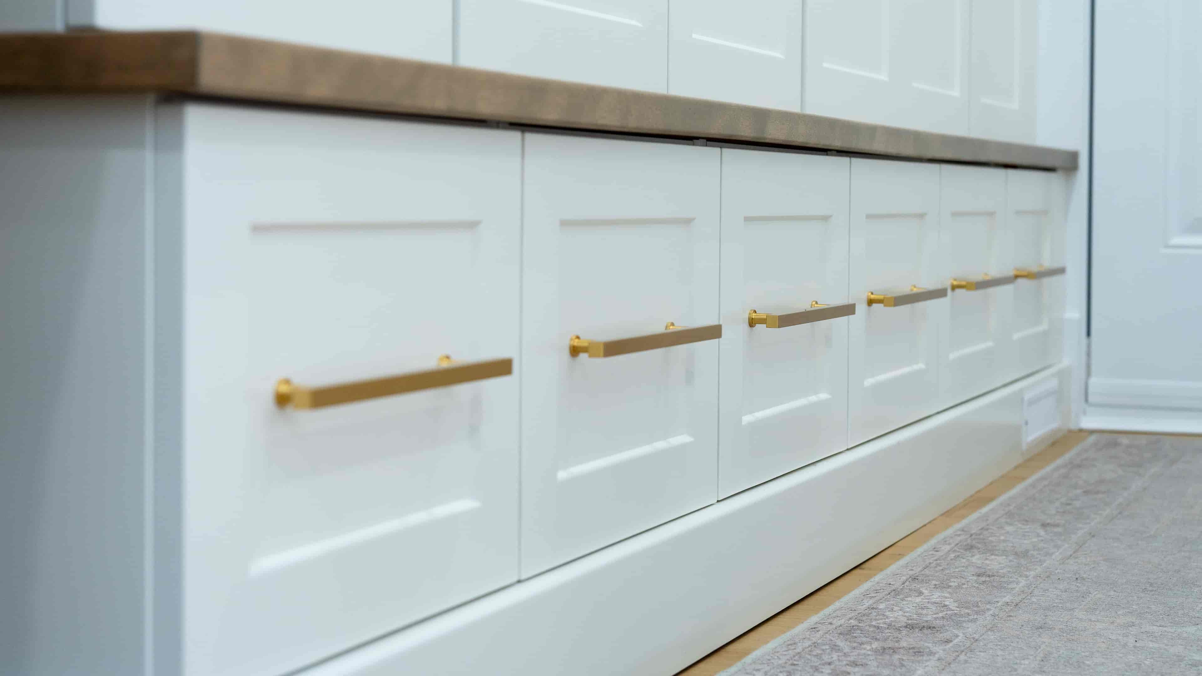 White storage cabinets with gold handle